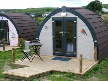 Glamping pod exterior with outdoor seating area
