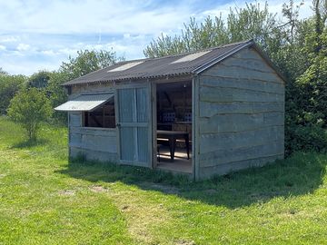 The field kitchen has fridges; a hob; a large table and kettle / toaster...