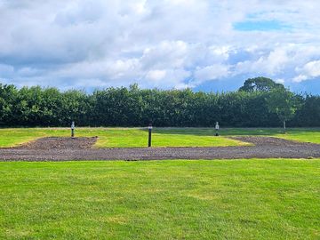 Hardstanding pitch with grass and electric hook-up