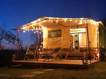 Safari tent lit up at night