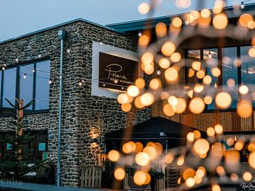 Restaurant at the campsite with illuminated entrance area and cozy atmosphere.
