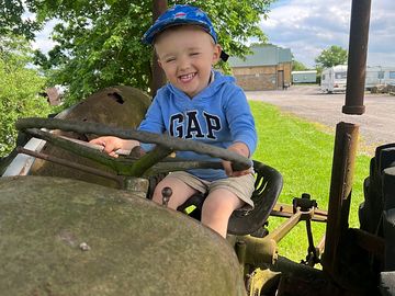 Tommy enjoying the old tractor at poplar grove (added by manager 04 jun 2024)