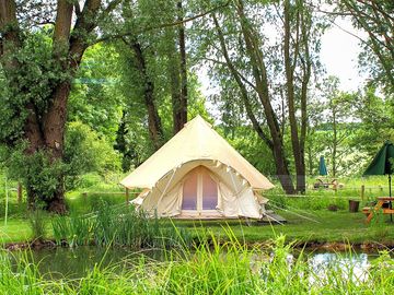 The new baby-bell tent, nestled beneath the trees, overlooking it's own private pond.