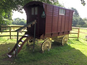 Shepherd's huts and a real gypsy caravan in the paddock overlooking the river and pub