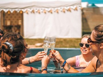 Hot tub with group enjoying a glass of bubbles at nesta valley in 2022