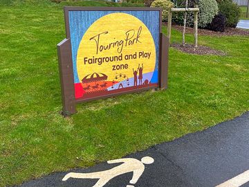 Tarmac roads and marked pathways around site.