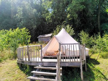 Apple tree bell tent on its platform