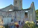 The ruined church next to a farm