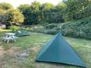 Level pitches on short grass with a few picnic benches