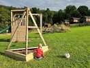 Play swing set and football goal looking back on the pods.