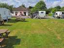 Grassed area, reception toilet shower block to the left