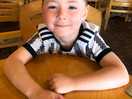 Callum in restraint waiting on his yummy breakfast