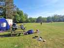 Pitched next to caravan in almost empty field. lake field.