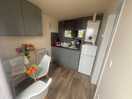 Small electrical cooking appliance in one of the cupboards too. iron, small ironing board
