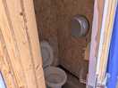 One of the two male cubicles. head and knees touch the door when seated as it is very small.