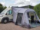 Campervan on fully serviced hardstanding pitch with awning.