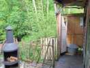 Small outdoor, sheltered shower room with hot water.