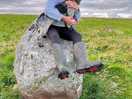 My daughter and rosie sitting on the last standing stone which is the same age as stonehenge.