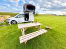 Clean camping pitch with picnic tables available