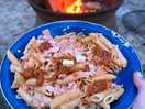 Cooked salmon pasta by the fire