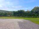 Level gravel pitches for motor homes views of the hills but not the sea.