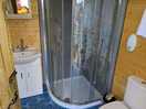 Compact bathroom with addition of heater to pre-warm the space before showering