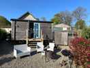 Shepherds hut with the bathroom facilities alongside.