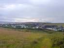 From the dog walking field down across the site.