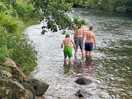 Happy kids playing in the river which you are literally parked at the side of!