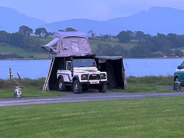 Roof tent on edge of the water