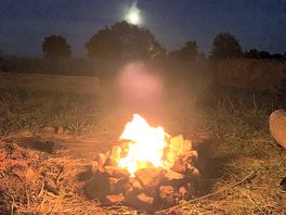 Nice campfire with the moon in the background