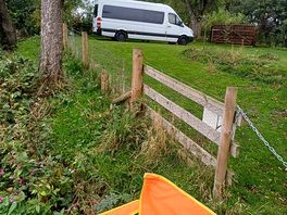 Orange seat on platform overlooking river swale.