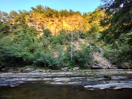 River and cliffs alongside of site.