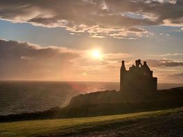 Sunset over castle from caravan.