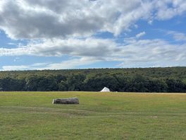 The middle section of the field, empty except for two bell tented