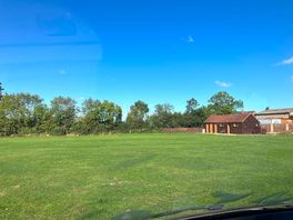 The flat site with the toilet block in the corner