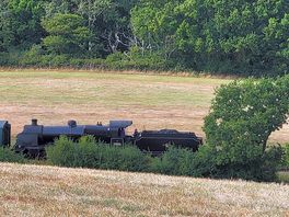 Steam train at the bottom of the field
