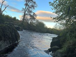 River beside the site as sun setting