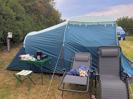 Tent set up with chairs and westie