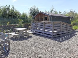 Exterior of the Robin's Nest has a picnic table and a barbecue area
