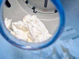 Dirty toilet roll in the dispenser.
