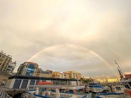 Sitting by the harbour eating and drinking whilst a storm rolled through.