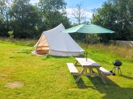 Bell tent complete with picnic table and charcoal BBQ