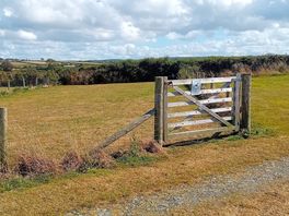A well fenced in dog exercise area, next to this is a well fenced play park for the children to play