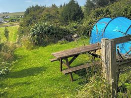 Hilly pitch by woodland