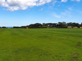 Open field; you can camp next to the pods if you're in a group