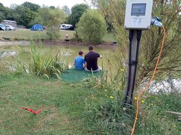 View from our tent to the ledge by the fishing lake.