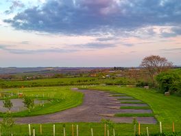 Grass pitches at the bottom and gravel to the right