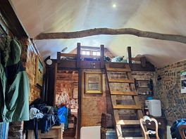 The mazanine bedroom with shower and toilet underneath