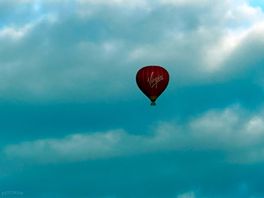 Virgin balloon flying from field